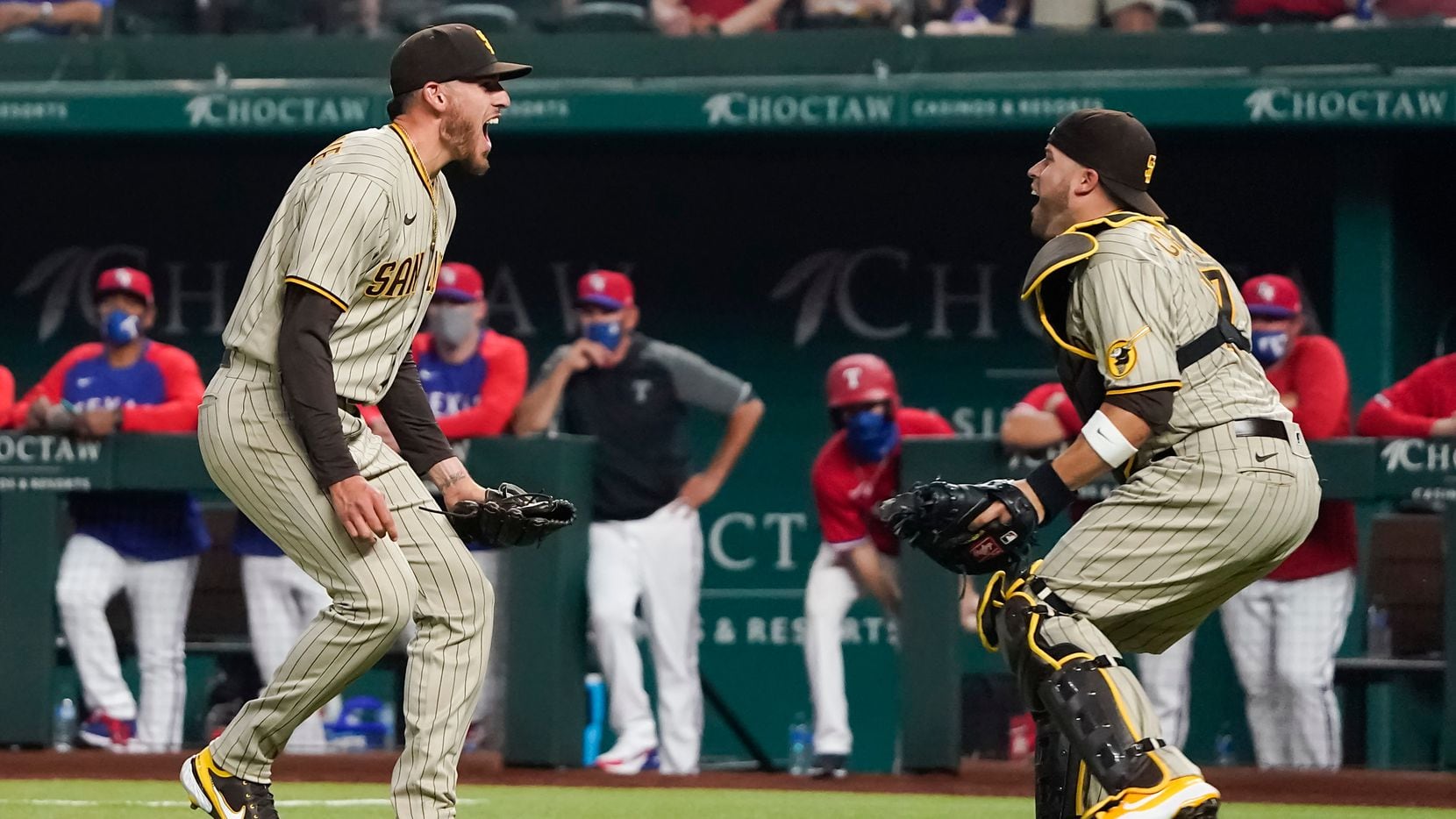 San Diego Padres starting pitcher Joe Musgrove celebrates with catcher Victor Caratini after the final out of a no-hitter over the Texas Rangers at Globe Life Field on April 9, 2021.