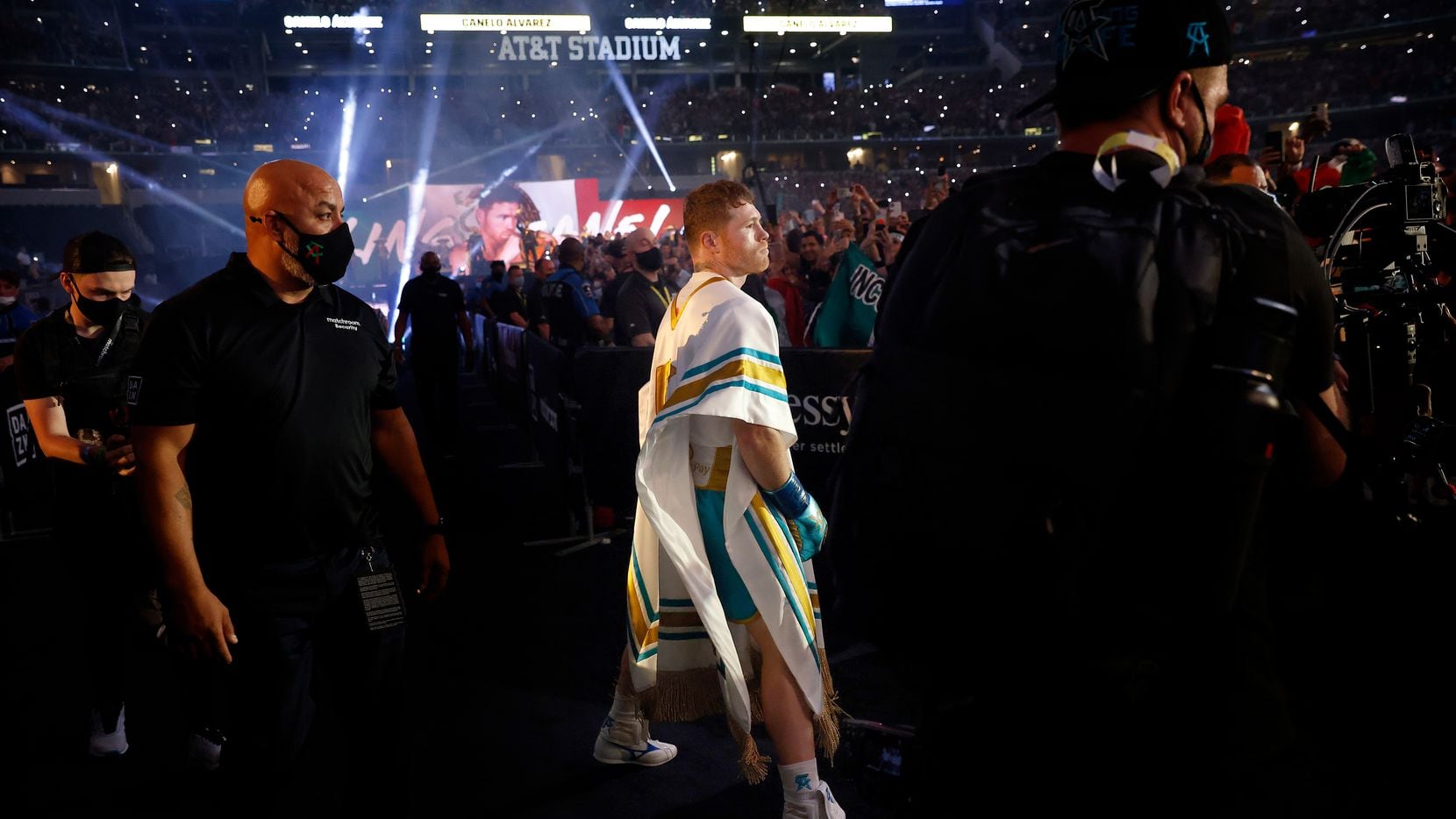 Boxer Canelo Alvarez struts to the ring as he's introduced to a mostly favorable crowd before his super middleweight title fight against Billy Joe Saunders at AT&T Stadium in Arlington, Saturday, May 8, 2021.
