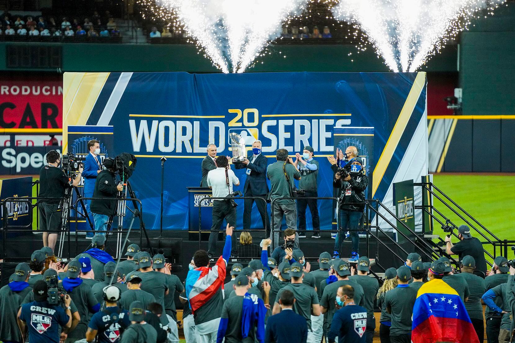 Major League Baseball commissioner Rob Manfred presents the championship trophy to the Los...
