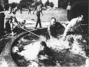 SMU students participate in tug of war at SMU fountain in 1958