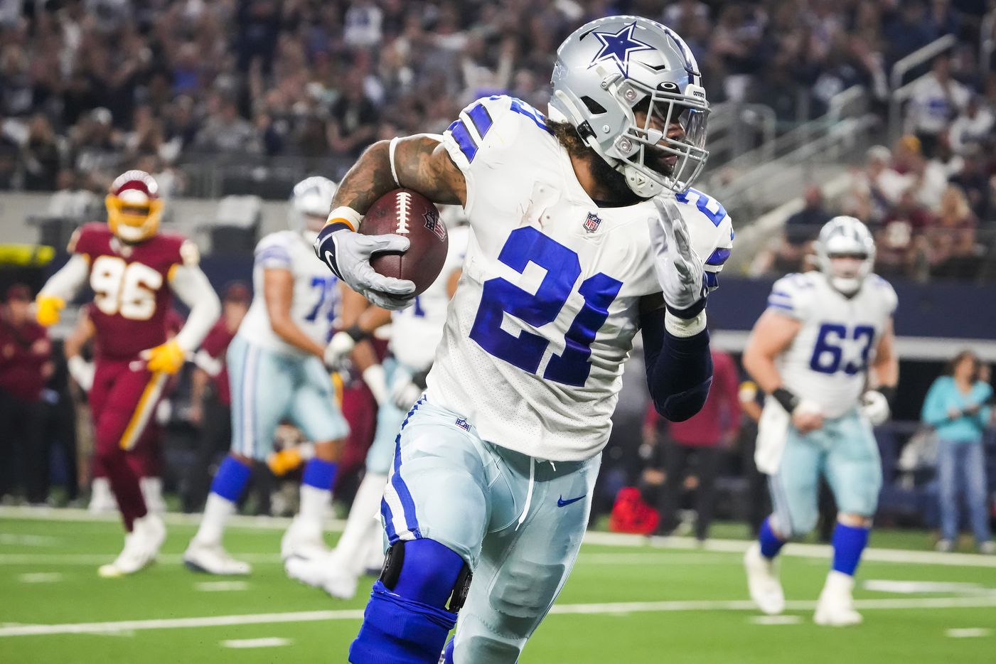 Dallas Cowboys running back Ezekiel Elliott (21) scores on a pass receptions during the first half of an NFL football game against the Washington Football Team at AT&T Stadium on Sunday, Dec. 26, 2021, in Arlington.