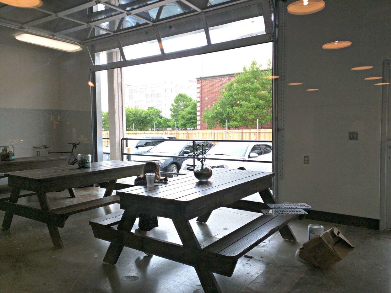The West 7th location features an enclosed patio with a sliding garage door.