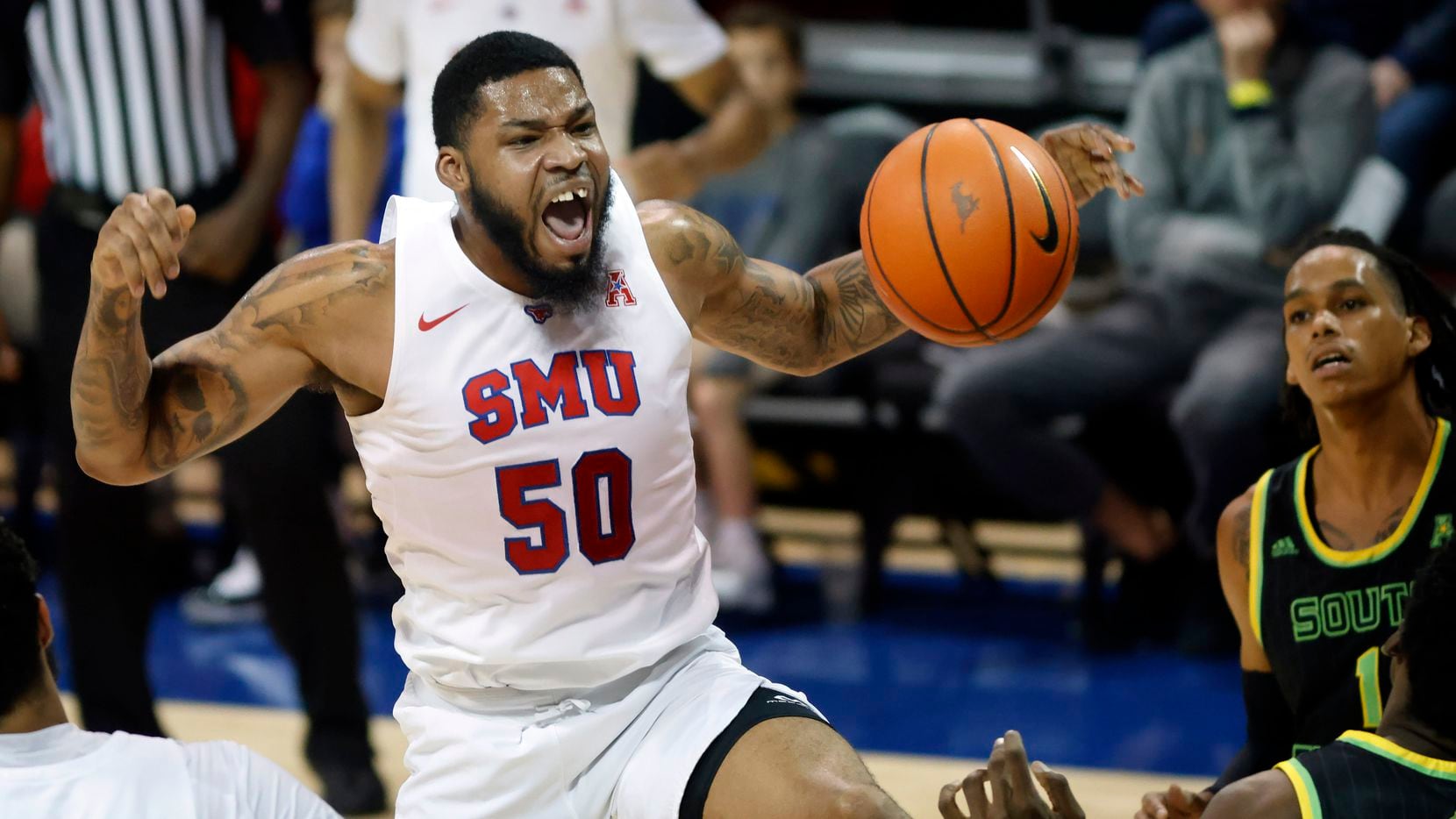 Southern Methodist Mustangs forward Marcus Weathers (50) reacts after driving the baseline...