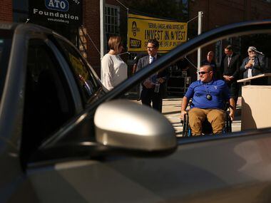 DART Detective Justin Ellis examines his new car after receiving a customized Toyota Camry...