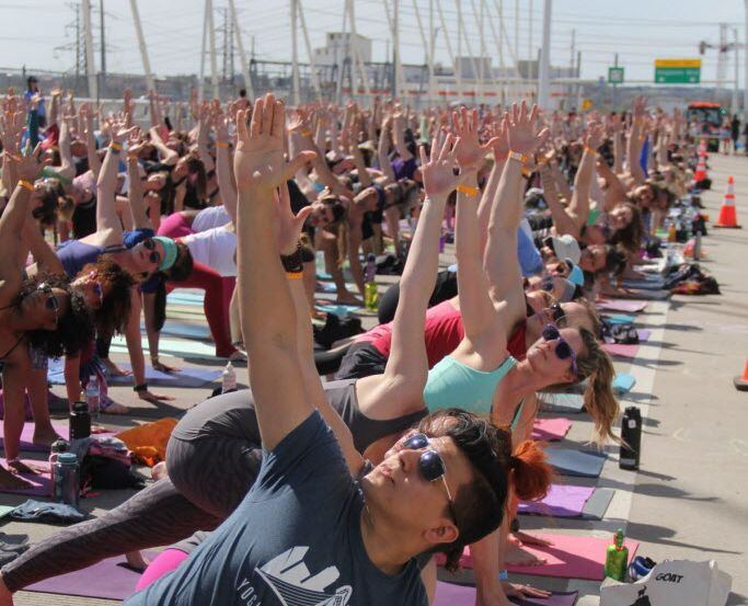A yoga session on the Margaret Hunt Hill Bridge is part of the All Out Trinity outdoor...