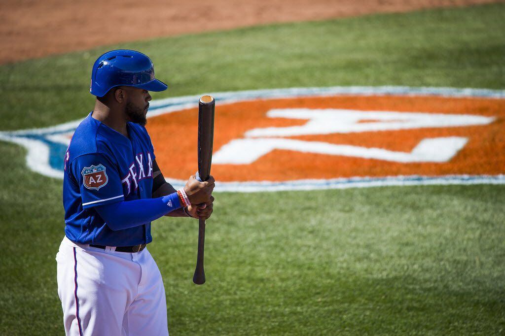 Texas Rangers outfielder Delino DeShields prepares to bat in the on deck circle during a...