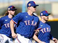Texas Rangers outfielder Travis Jankowski, left, third baseman Josh Jung, center, and...