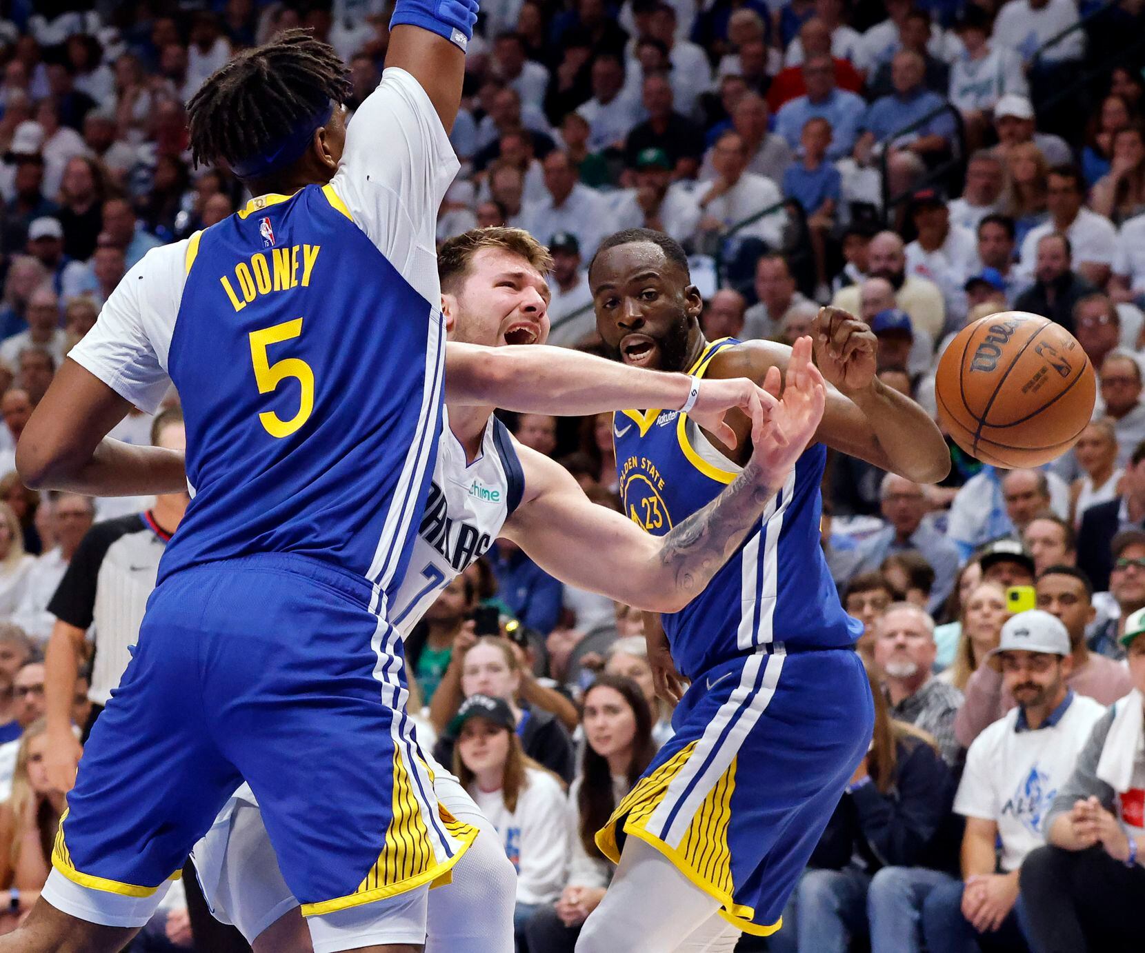 Dallas Mavericks guard Luka Doncic (77) is fouled by Golden State Warriors center Kevon...