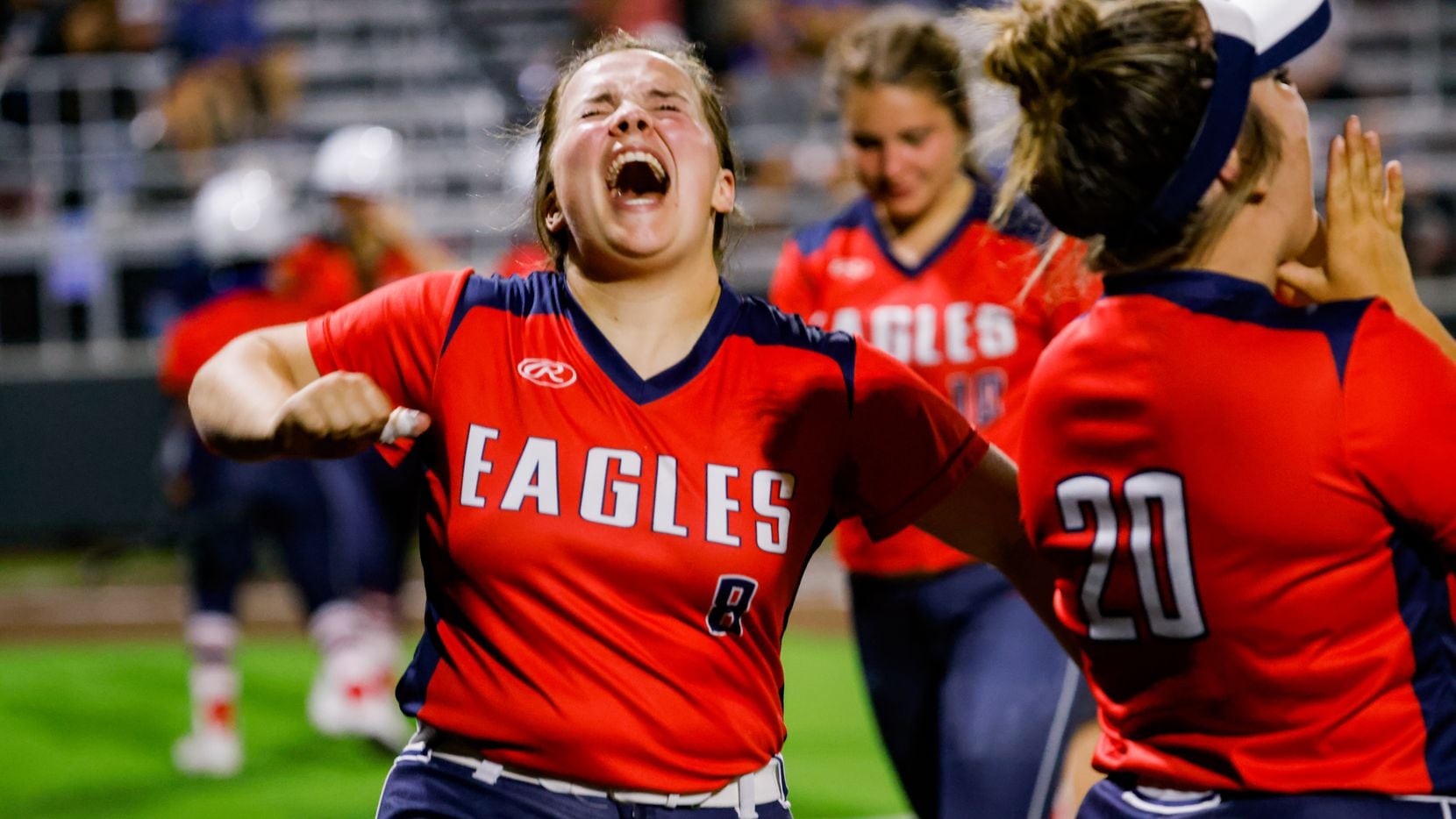 Allen's Taylor Wright (8) celebrates a two-run double by Celeste McCary during a four-run seventh inning in Allen's 8-2 win over Denton Guyer in a District 5-6A softball game Tuesday. (Juan Figueroa/The Dallas Morning News)