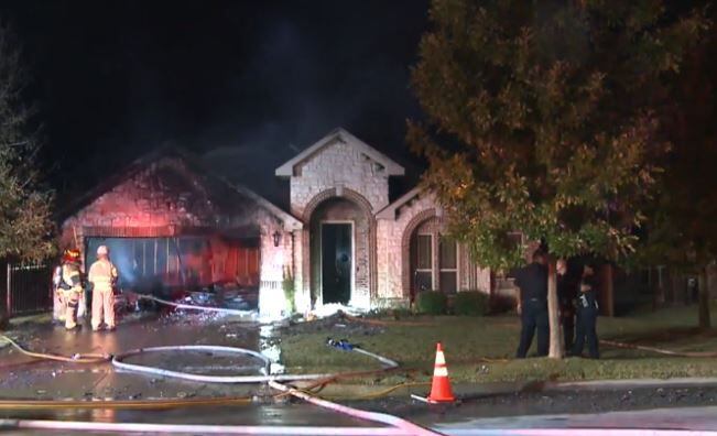 Mansfield firefighters take stock of a blaze that heavily damaged a home with an 11-year-old...