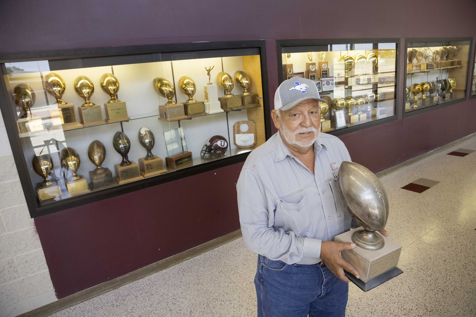 Former Uvalde football state champion Richard Sanchez holds the 1972 Uvalde Football state...
