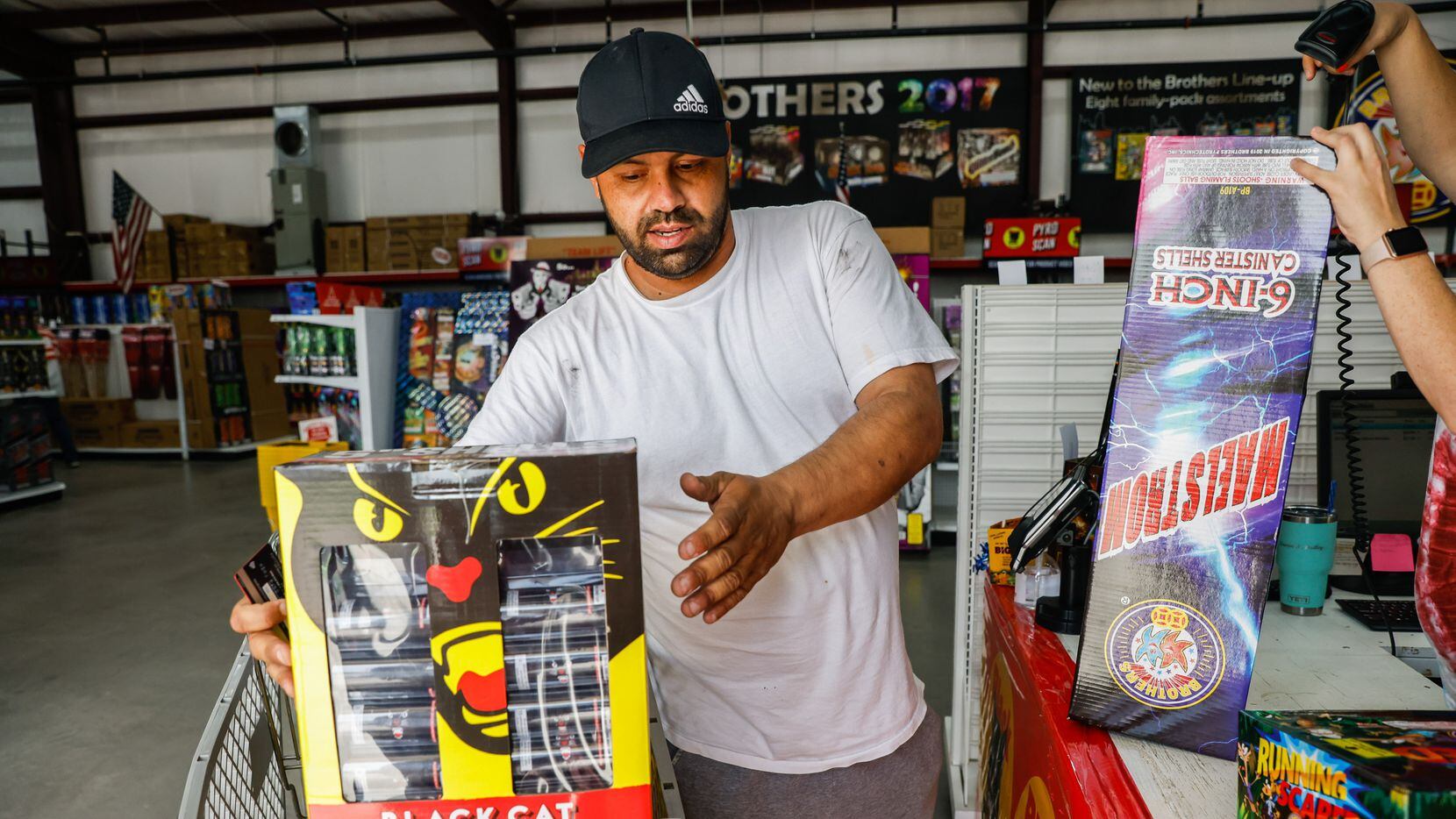 Orlando Ornelas, 39, checks out at the cash register at Nelson's Fireworks store in Rockwall...