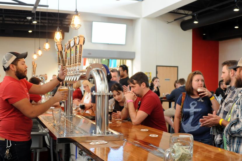 Bartender Quin Tinling serves a cold brew at Lakewood Brewing Company's grand opening of the...