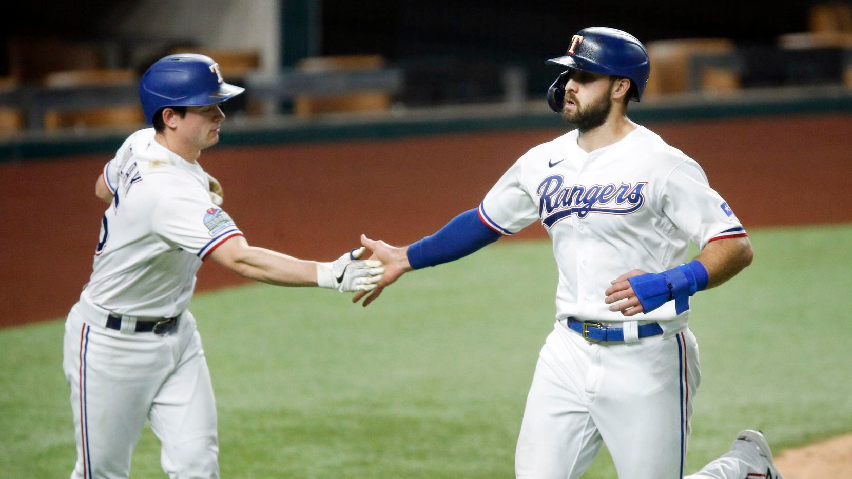 Texas Rangers Joey Gallo (right) is congratulated by teammate Nick Solak after they both...