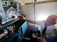 Southwest Airlines Capt. Bill Lusk explains to reporters what the radar is showing in this...