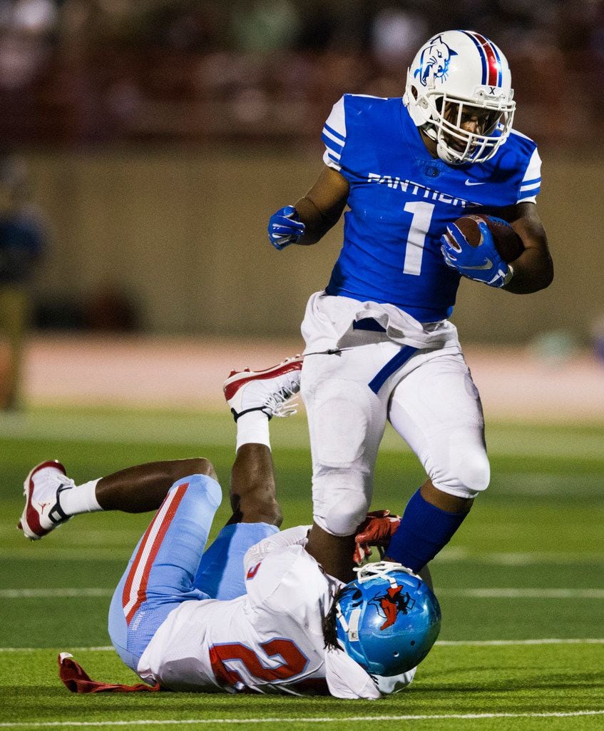 Duncanville running back Trysten Smith (1) is tackled by Skyline defensive back Rodgret...