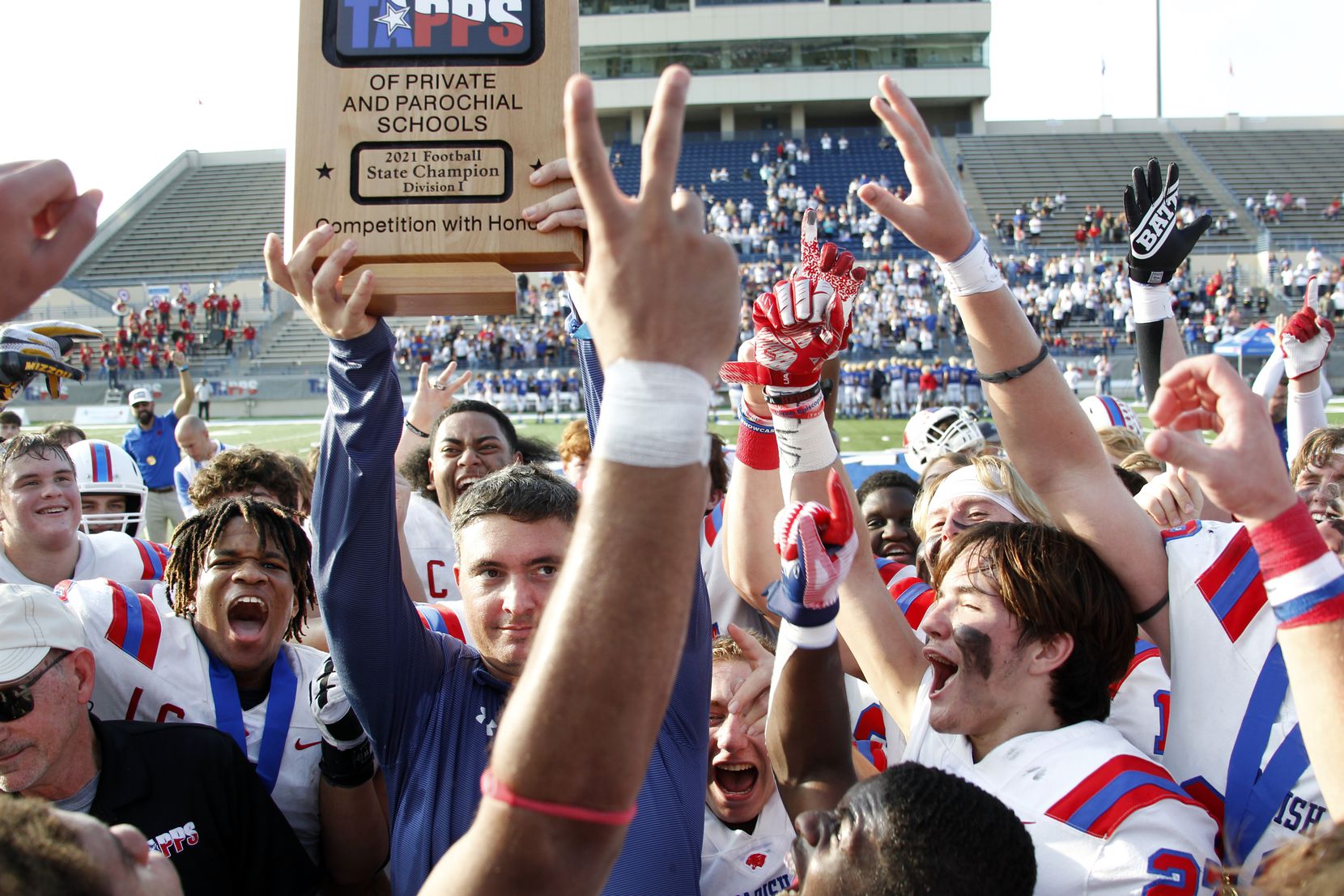 Parish Episcopal head football coach Daniel Novakov hoists the state title trophy to the excitement of his players following their 56-17 victory over Midland Christian in the championship game. The two teams played their TAPPS Division 1 state championship football game at Waco ISD Stadium in Waco on December 4, 2021. (Steve Hamm/ Special Contributor)
