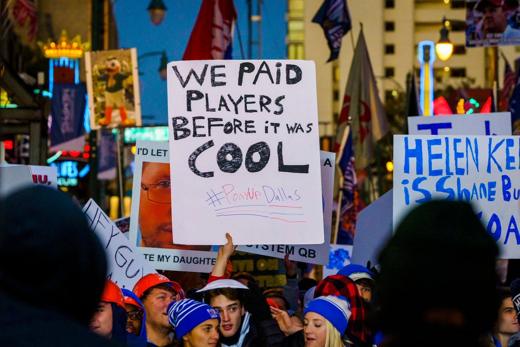 A fan holds up a sign reading ÒWe Paid Players Before it was Cool,Ó during ESPN College...
