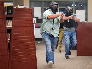 Two school marshals participate in a school safety active shooter training demonstration...