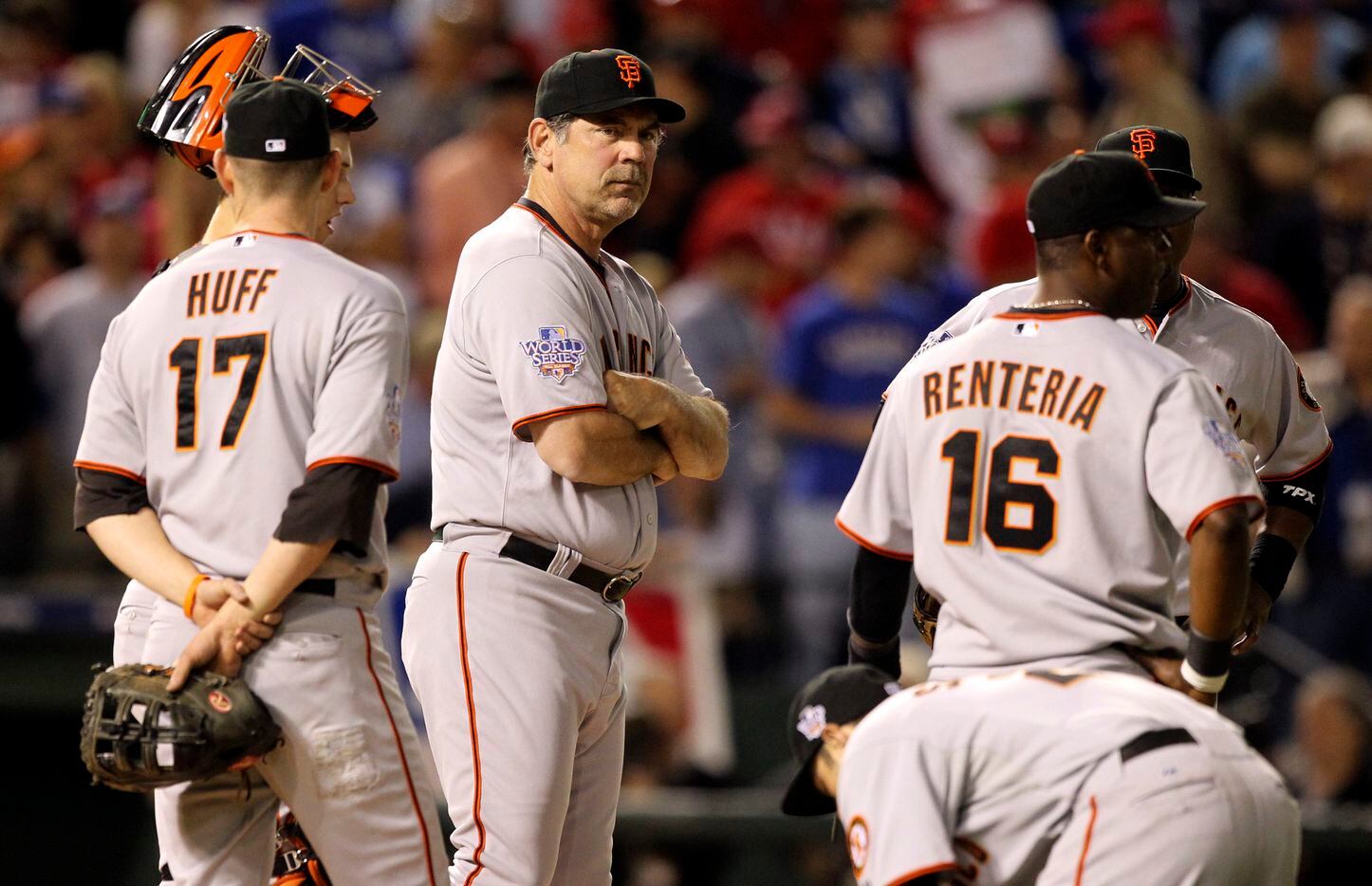 Manager Bruce Bochy stands on the mound with San Francisco Giants infielders after starting...