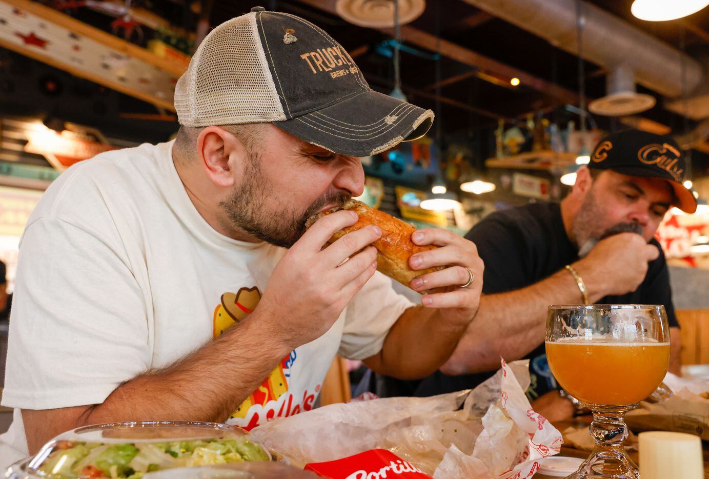 Nick Tague takes his first bite of Portillo’s Italian Beef at the new Portillo’s in The...