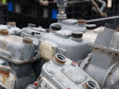 Gas meters removed from houses are gathered near a temporary headquarters in a neighborhood...