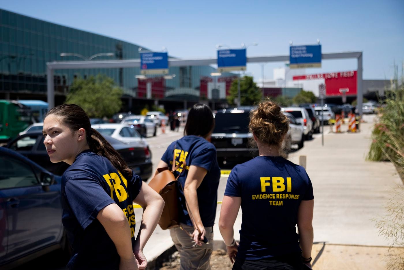 Members of the FBI Evidence Response Team arrive at the scene as Dallas police investigate...