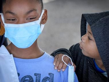 Ten-year-old Kaya Rojo receives encouragement from her little brother Keri Rojo before receiving her coronavirus vaccine at the command post outside the Wilkerson Greens Activity Center in Fort Worth, Texas on November 4, 2021. (Robert W. Hart/Special Contributor)