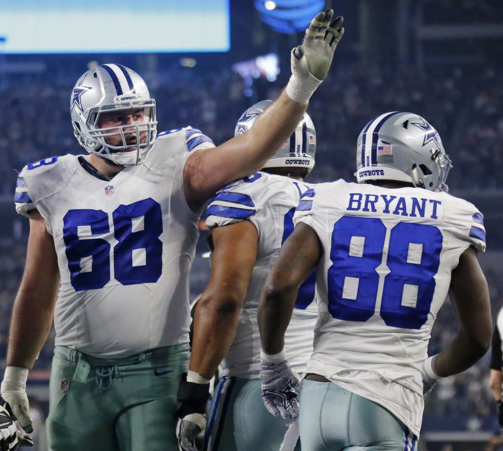 Dallas Cowboys tackle Doug Free (68) congratulates Dallas Cowboys wide receiver Dez Bryant (88) on a touchdown reception during the Detroit Lions vs. the Dallas Cowboys NFL football game at AT&T Stadium in Arlington, Texas on Monday, December 26, 2016. (Louis DeLuca/The Dallas Morning News)