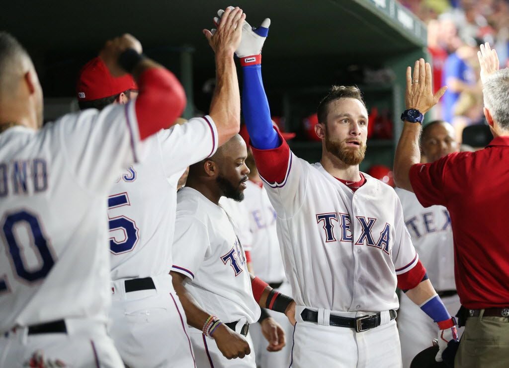 Texas Rangers catcher Jonathan Lucroy (25) celebrates with teammates after hitting a solo...