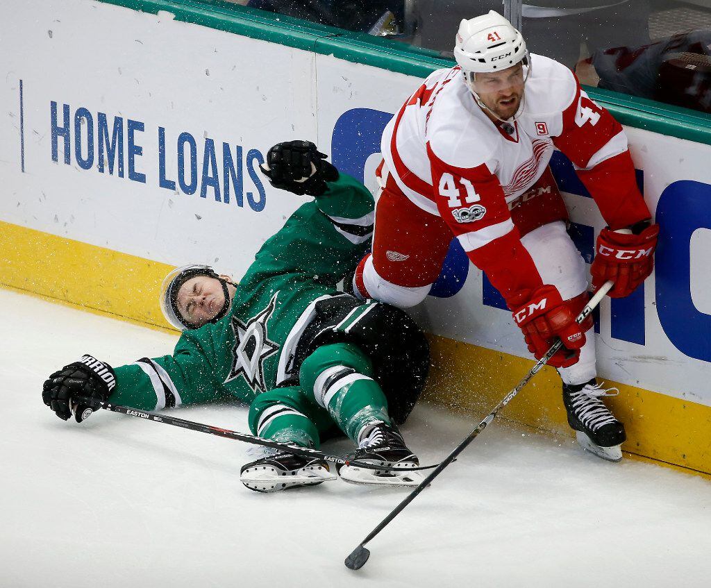 Dallas Stars right wing Jiri Hudler (22) hits the board after being checked by Detroit Red...