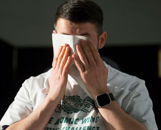 Jonathan Kussman wipes his eyes after placing second in the Wingstop Atomic Wing Eating...