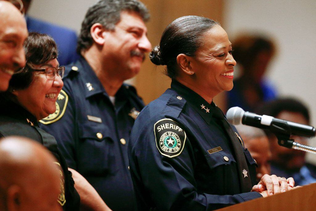 Lupe Valdez (left) smiled as Marian Brown was named interim county sheriff at the Dallas...
