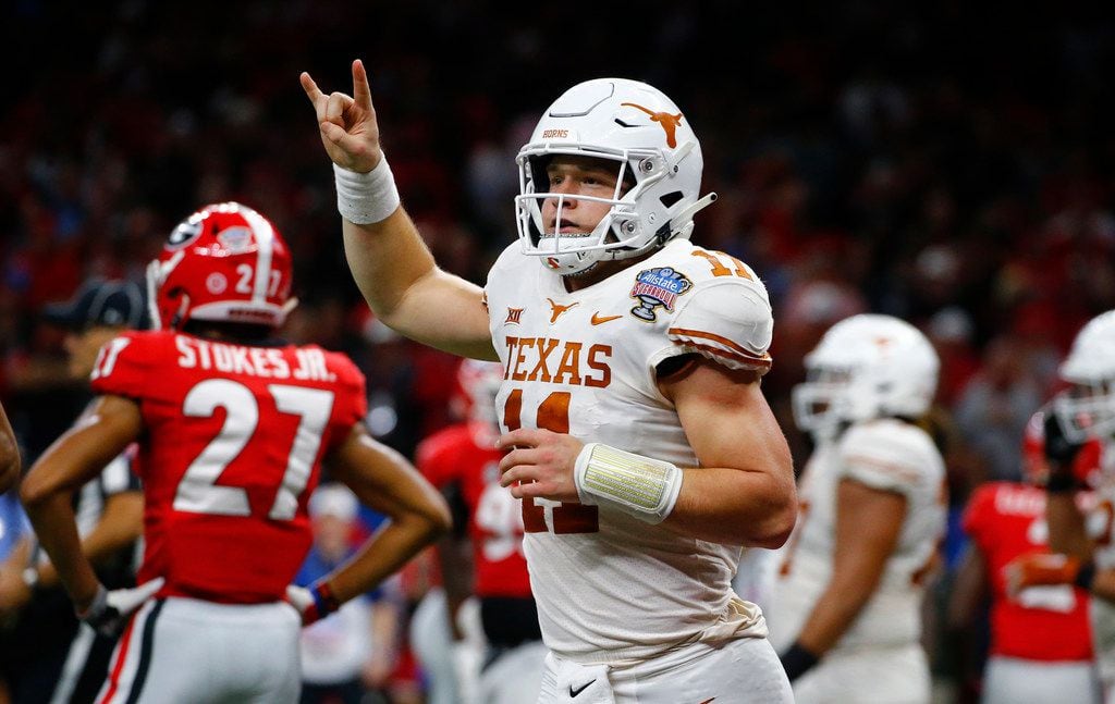 Texas quarterback Sam Ehlinger (11) celebrates his second touchdown carry in the first half...