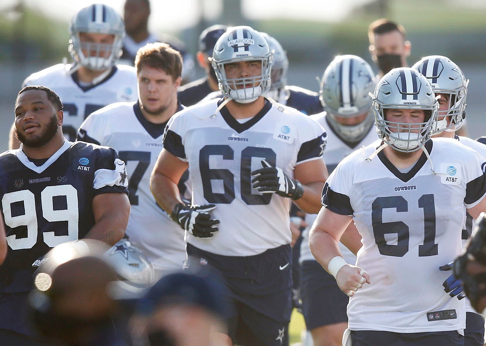 Dallas Cowboys offensive tackle Isaac Alarcón (60) takes the field with the team during the...