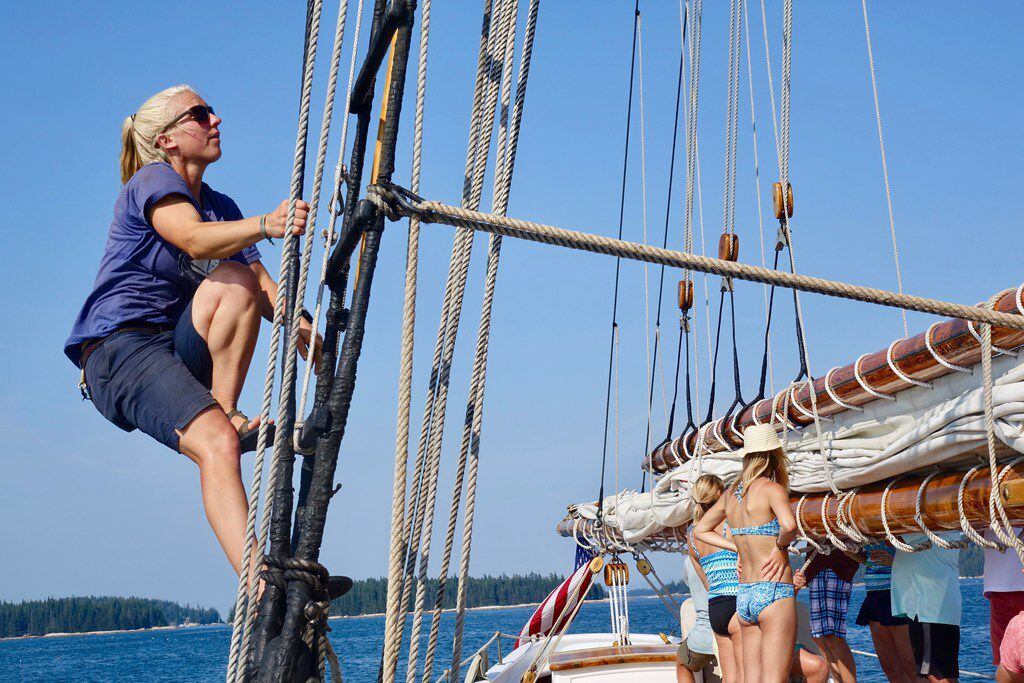 First mate Christa Miller-Shelley nears the top of the rigging on the starboard side of the...