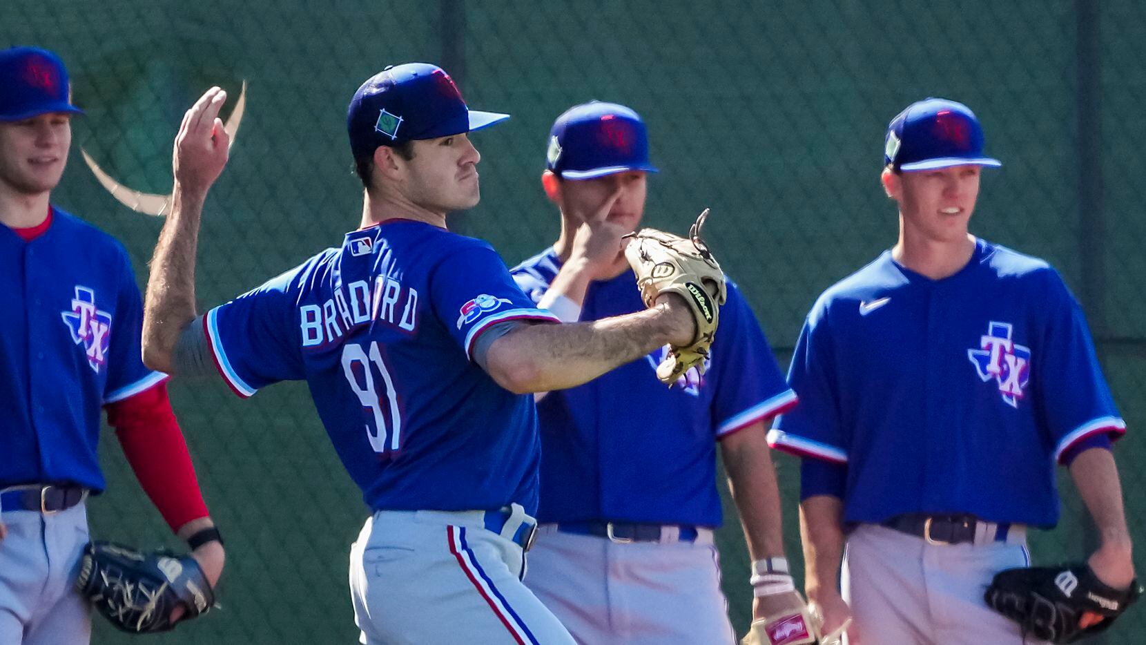Pitcher Cody Bradford participates in a drill during a Texas Rangers minor league spring...