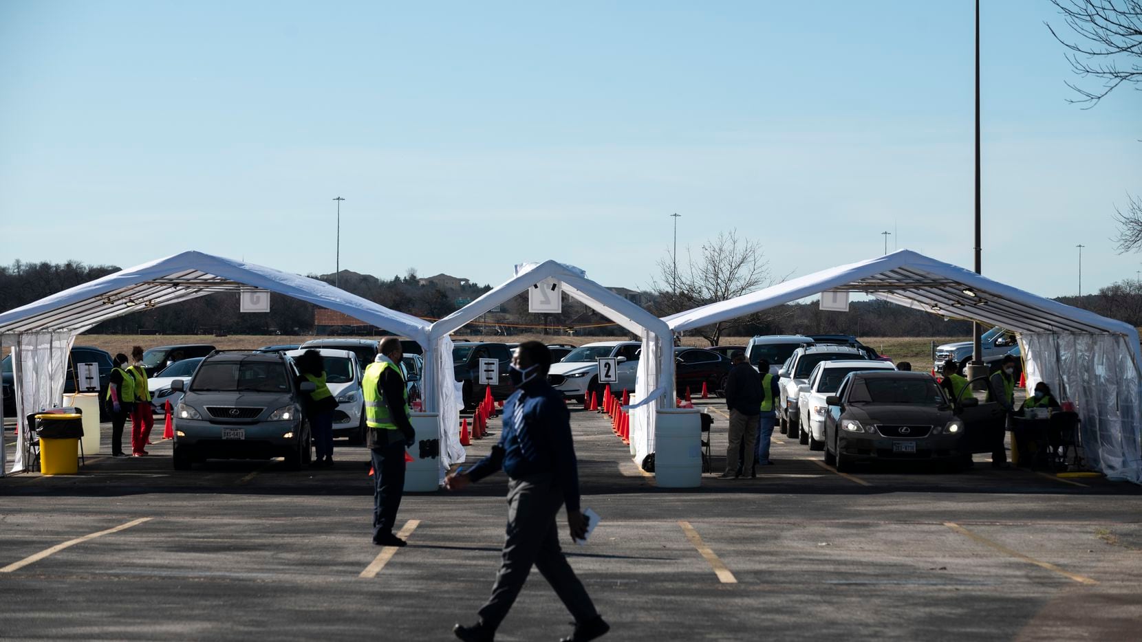 Medical workers administer COVID-19 vaccines under tents at the city of Dallas' new...
