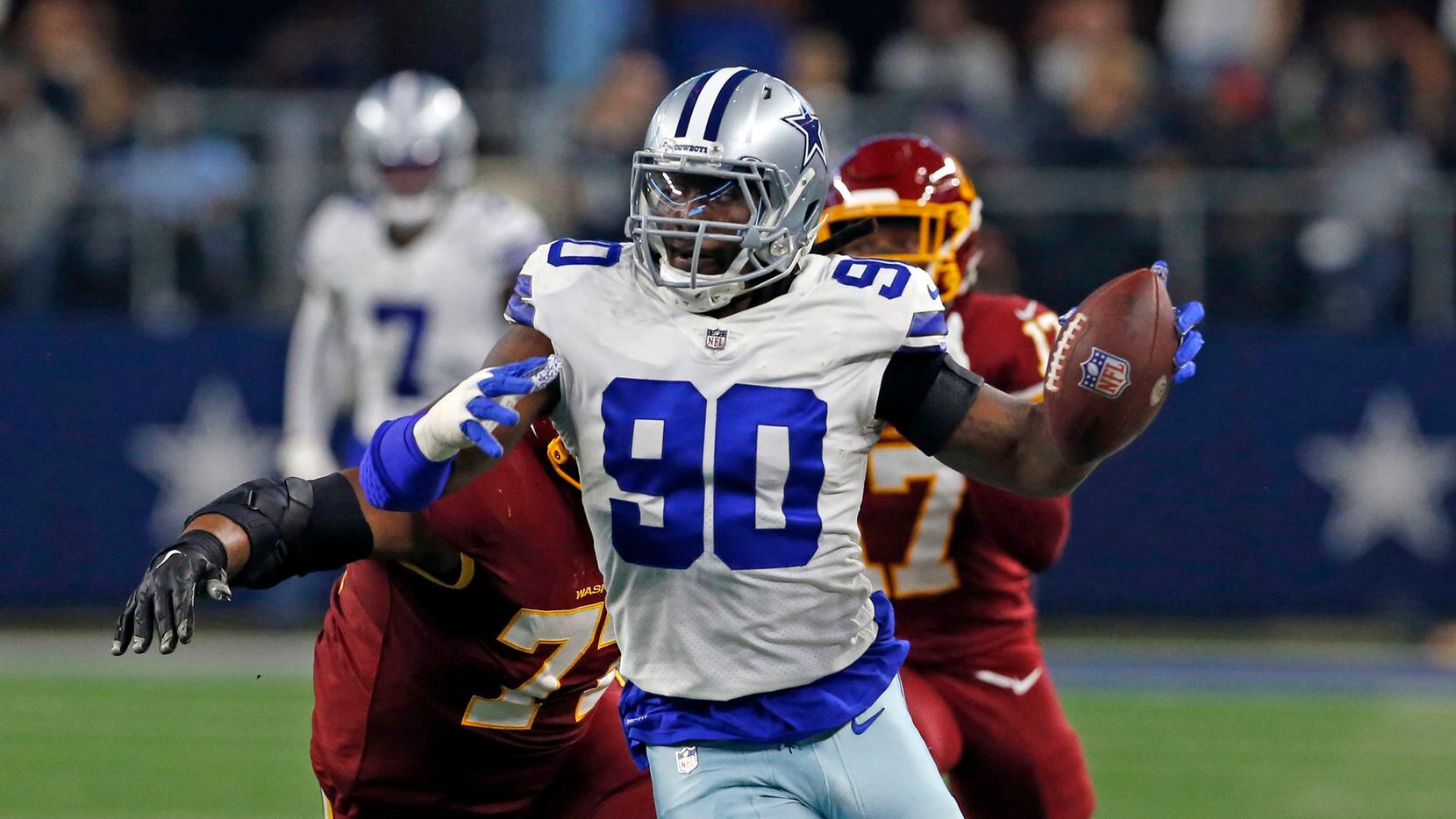 Dallas Cowboys defensive end Demarcus Lawrence (90) heads to the end zone for a touchdown,...