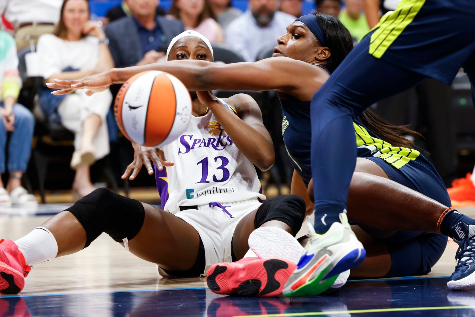 Dallas Wings center Teaira McCowan, right, attempts to block the pass of Los Angeles Sparks...