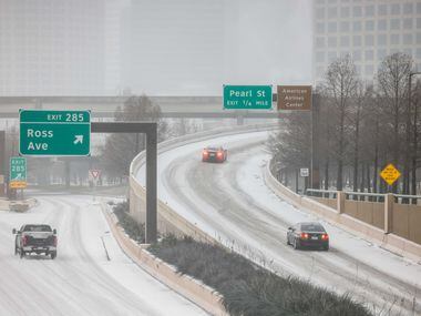 Road conditions for some motorists begin to become difficult as sleet falls over the Dallas...