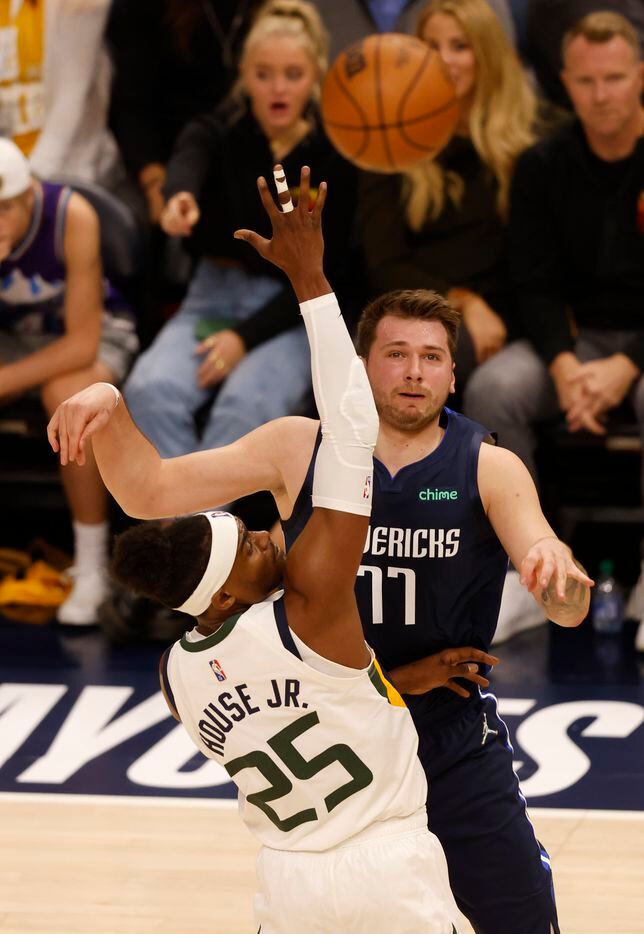 Dallas Mavericks guard Luka Doncic (77) passes across court as he is defended by Utah Jazz...