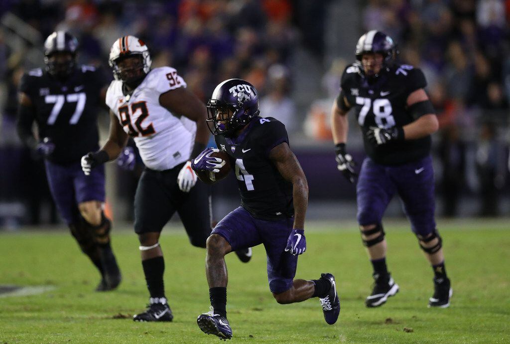 FORT WORTH, TEXAS - NOVEMBER 24:  Taye Barber #4 of the TCU Horned Frogs runs the ball...