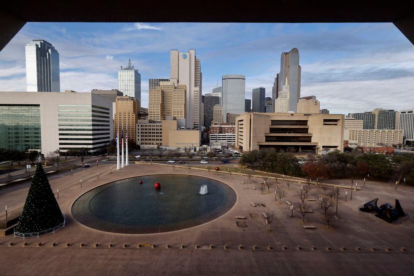 The 4.7 acre Dallas City Hall plaza is cut diagonally by a barrier in the form of an immense...