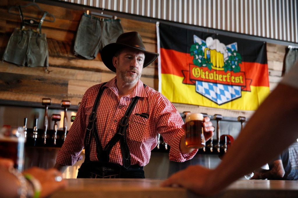 Cofounder Greg McCarthy serves a beer at Legal Draft Beer Co. in Arlington, Texas Oct. 1,...