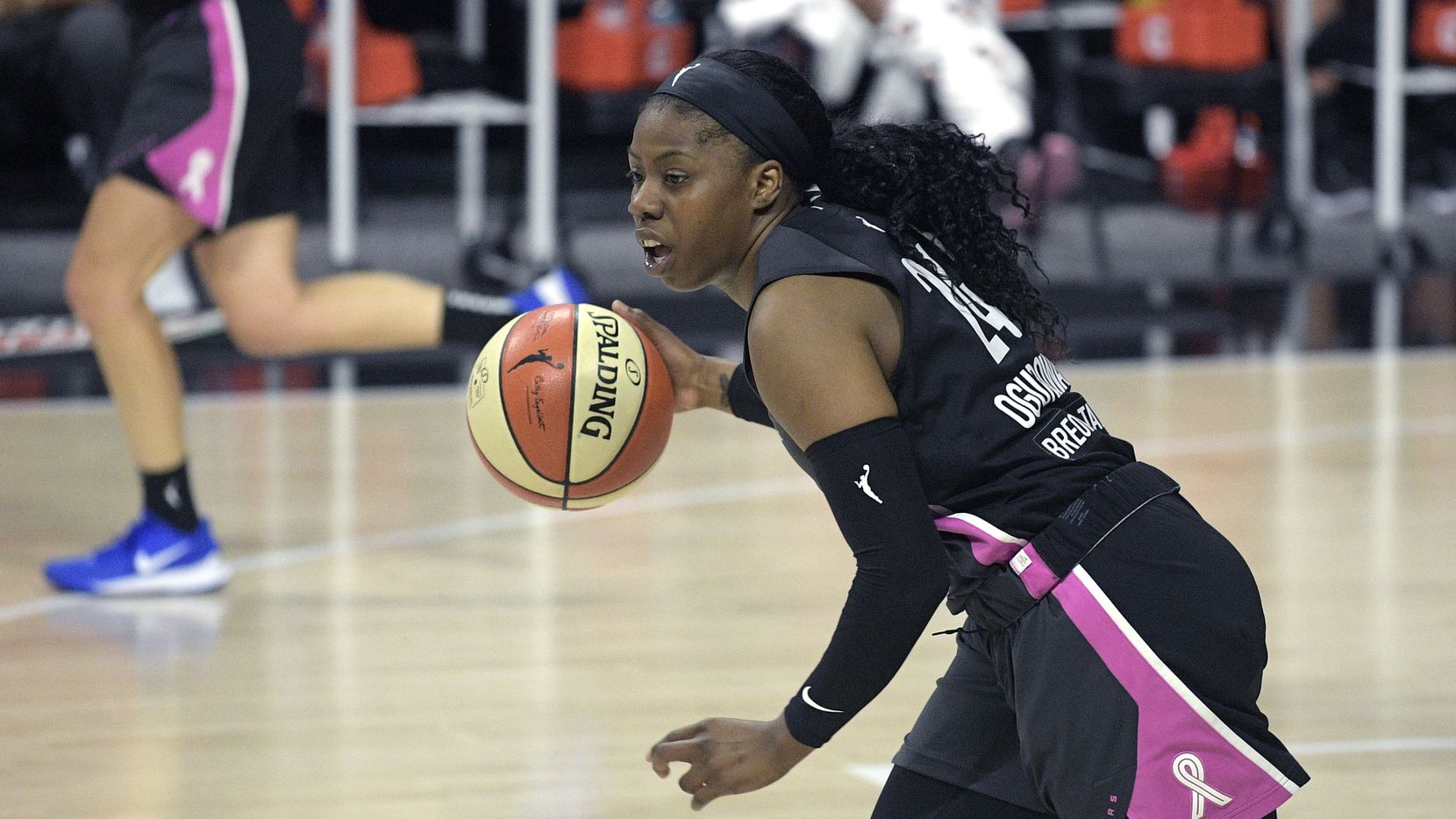 Dallas Wings guard Arike Ogunbowale (24) pushes the ball up the court during the first half of a WNBA basketball game against the Las Vegas Aces, Tuesday, Aug. 25, 2020, in Bradenton, Fla.