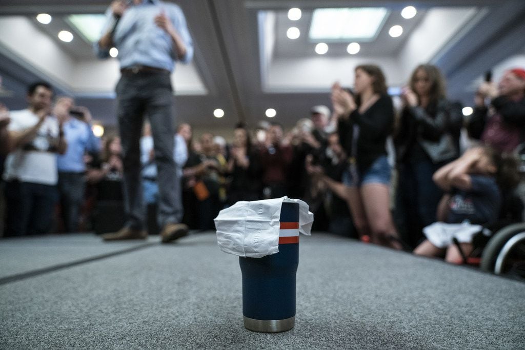 A napkin covers a coffee mug belonging to Beto O'Rourke as he speaks during a town hall in...