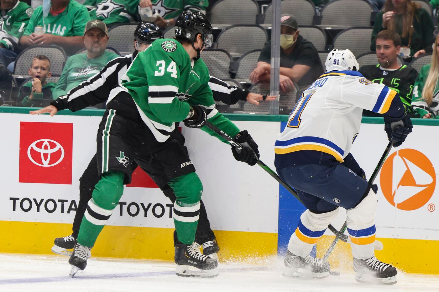 Dallas Stars right wing Denis Gurianov (34) battles St. Louis Blues right wing Vladimir Tarasenko (91) for the puck during the first period of a Dallas Stars preseason game against St. Louis Blues on Tuesday, Oct. 5, 2021, at American Airlines Center in Dallas. (Juan Figueroa/The Dallas Morning News)