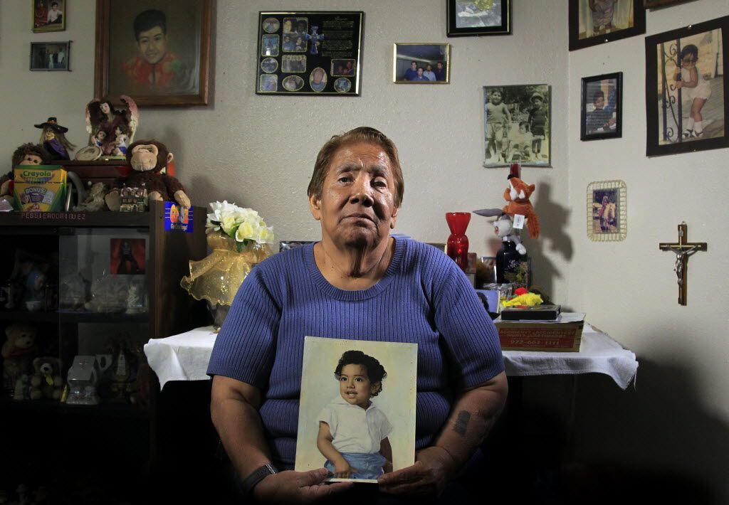 Bessie Rodriguez, the mother of Santos Rodriguez, holds a painting of her son in her Dallas...