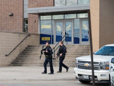 Two armed Arlington Police Officers outside of Lamar High School after a school shooting...